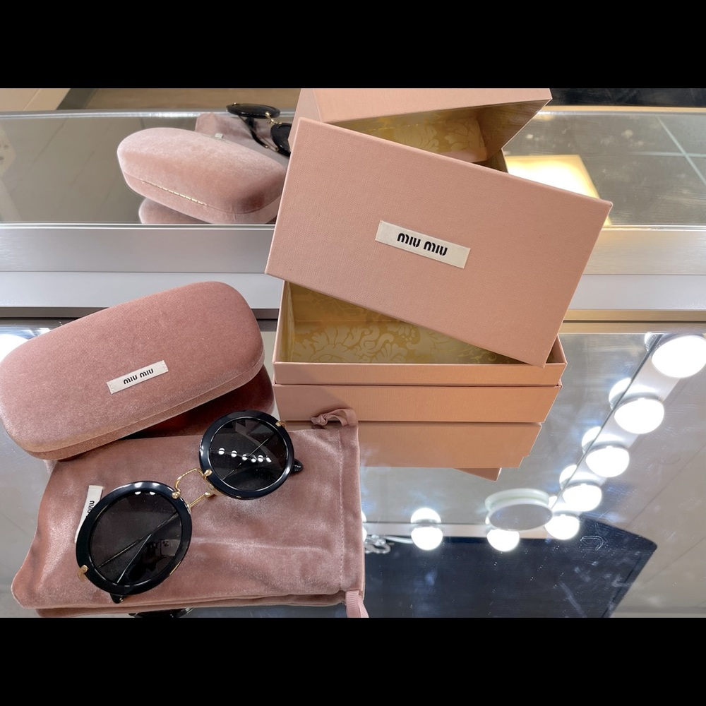 Miu Miu black and gold sun glasses